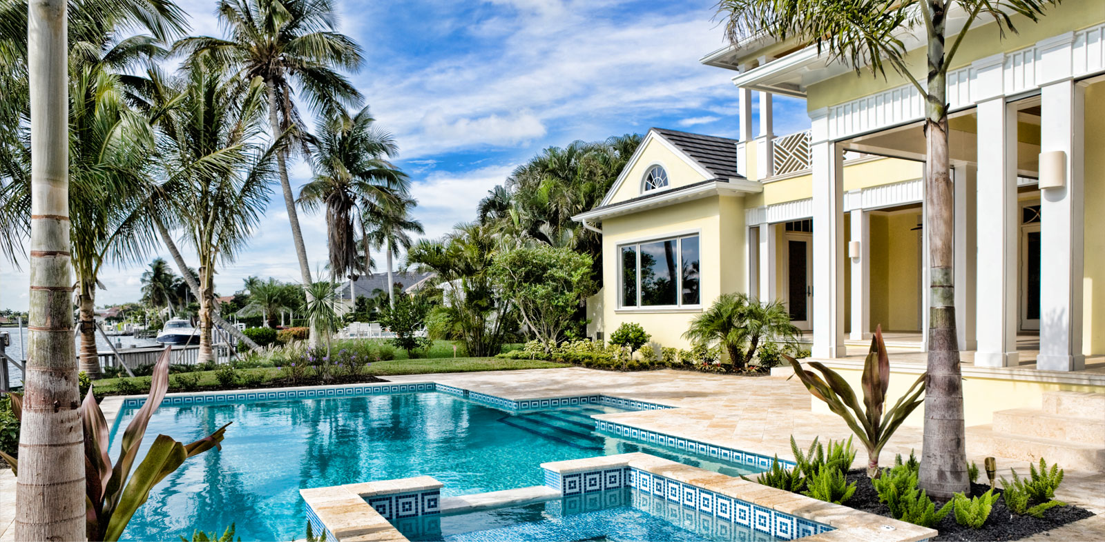 A luxury home with swimming pool and coconut trees