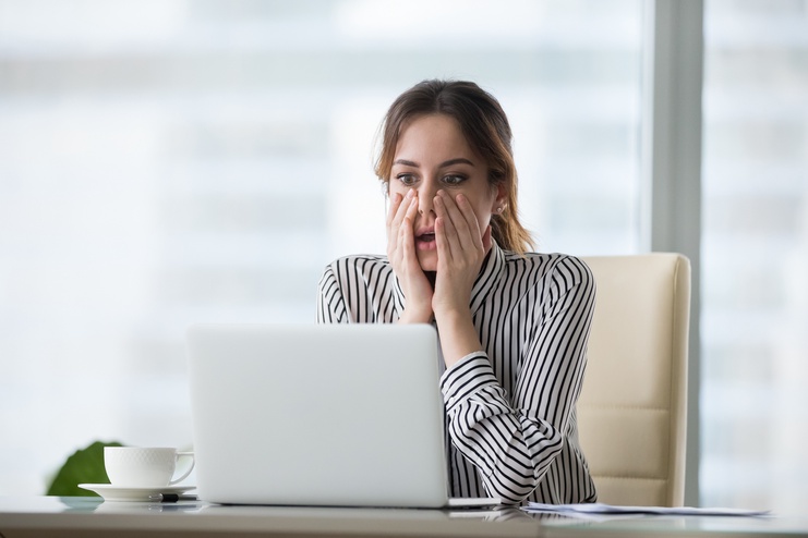 a female realtor looking to her laptop screen
