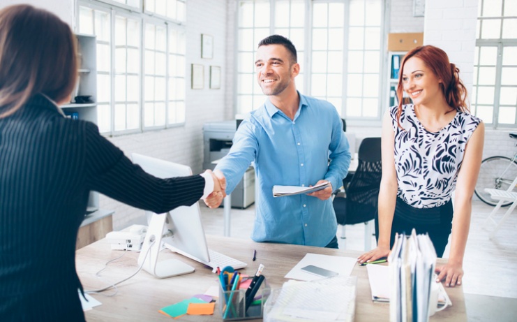 a man hand-shaking with his realtor after an interview